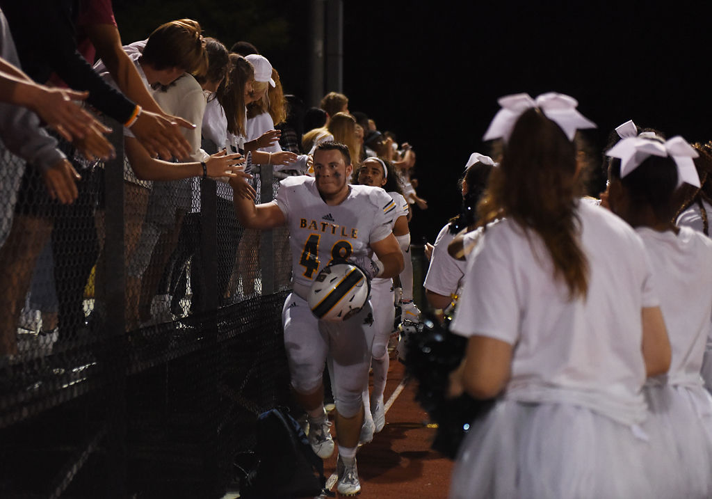 Battle High senior linebacker Landon Mahoney gives high fives